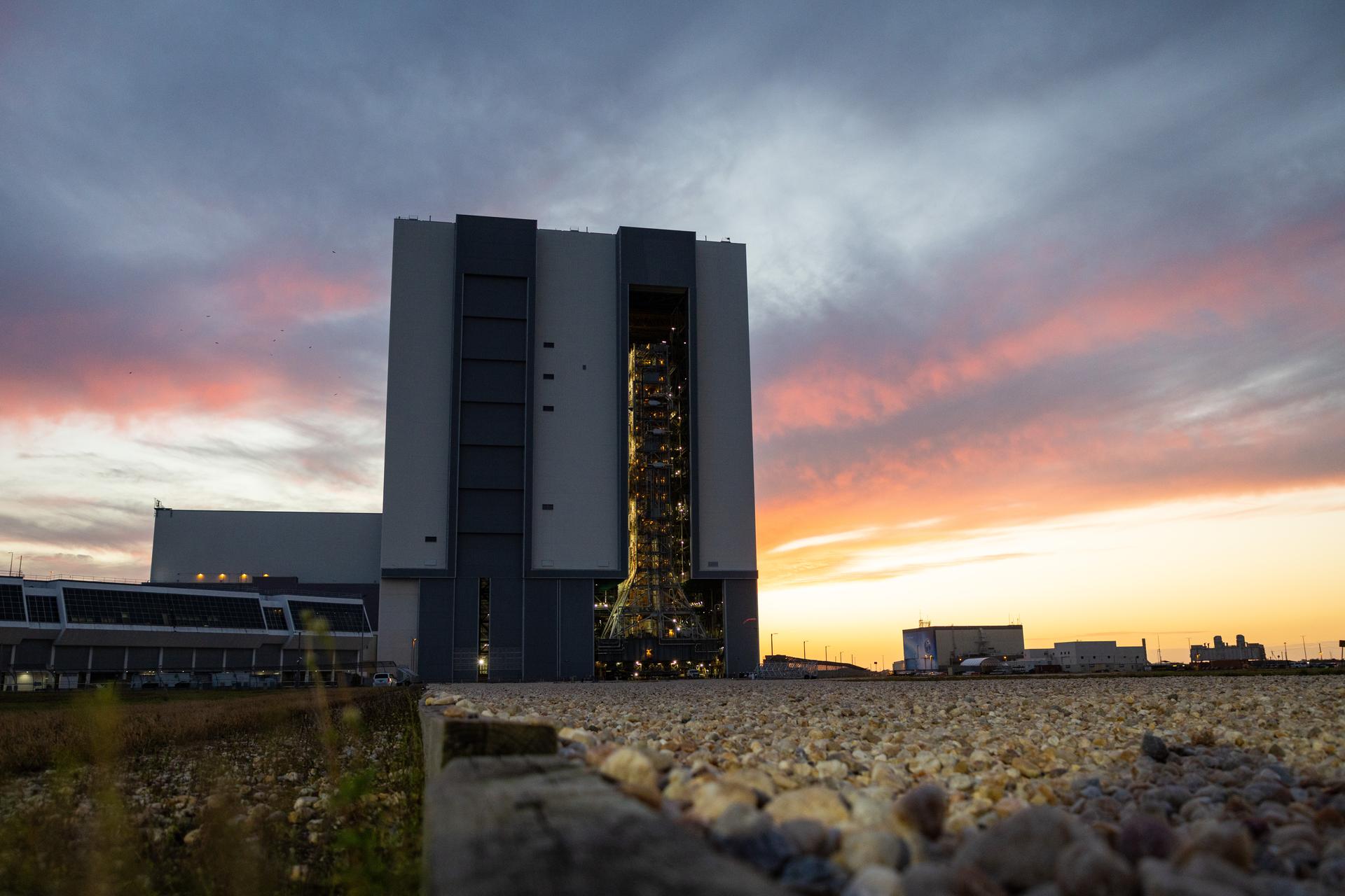 This image shows NASA’s SLS (Space Launch System) and Orion spacecraft rolling out of the Vehicle Assembly Building at NASA’s Kennedy Space Center. NASA's massive Crawler-Transporter, upgraded for the Artemis program, carries the powerful SLS rocket and Orion spacecraft on the Mobile Launcher from the Vehicle Assembly Building to Launch Pad 39B at Kennedy Space Center in preparation for the Artemis II mission.